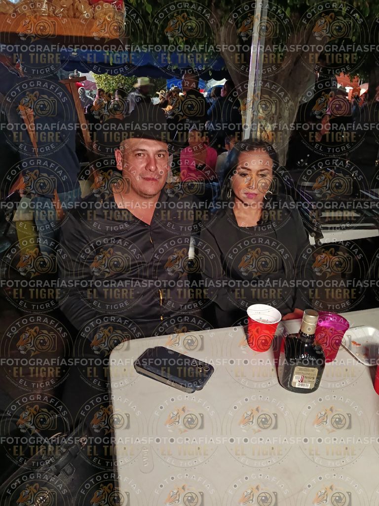 Pareja comparte un momento durante la feria